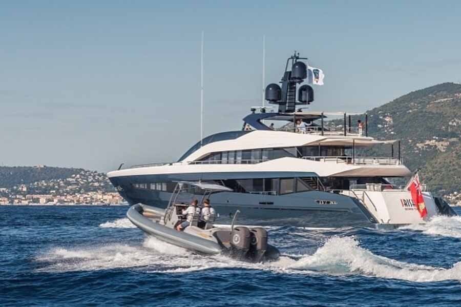 A large yacht is floating on top of a body of water.
