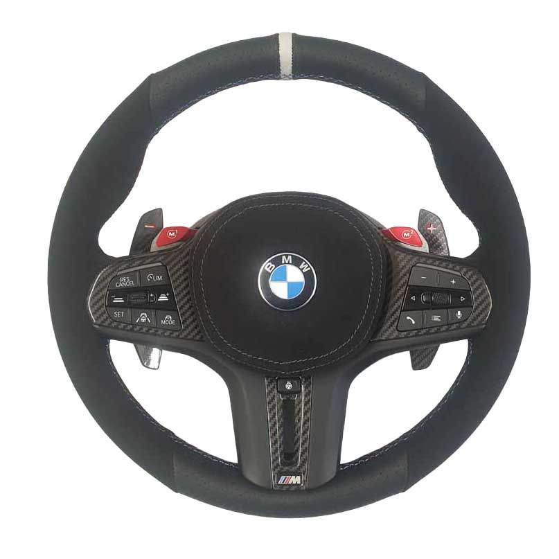 BMW steering wheel with black suede grip, carbon-fiber accents, and red buttons