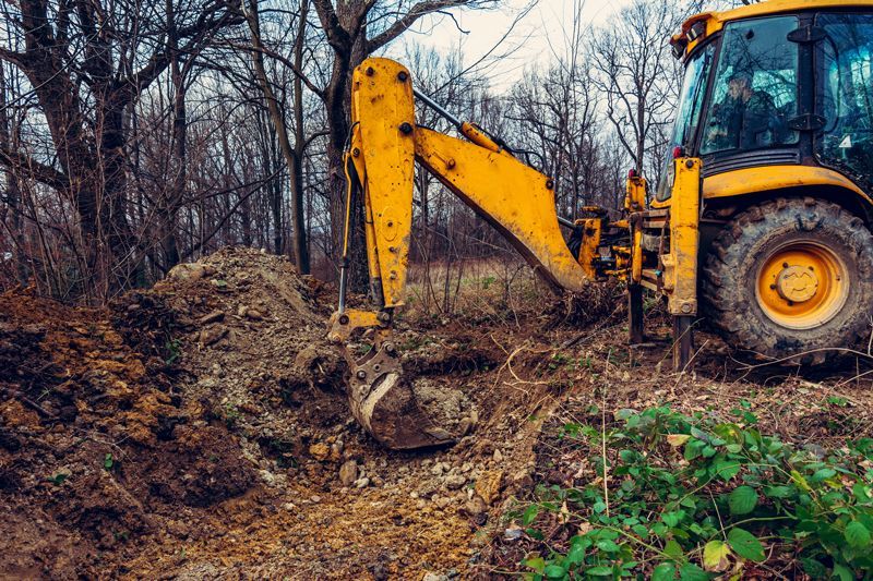 A Yellow Excavator Clearing Dig Soil - Aberdeen, MS - Ground Pounders A Yellow Excavator Clearing Dig Soil - Aberdeen, MS - Ground Pounders