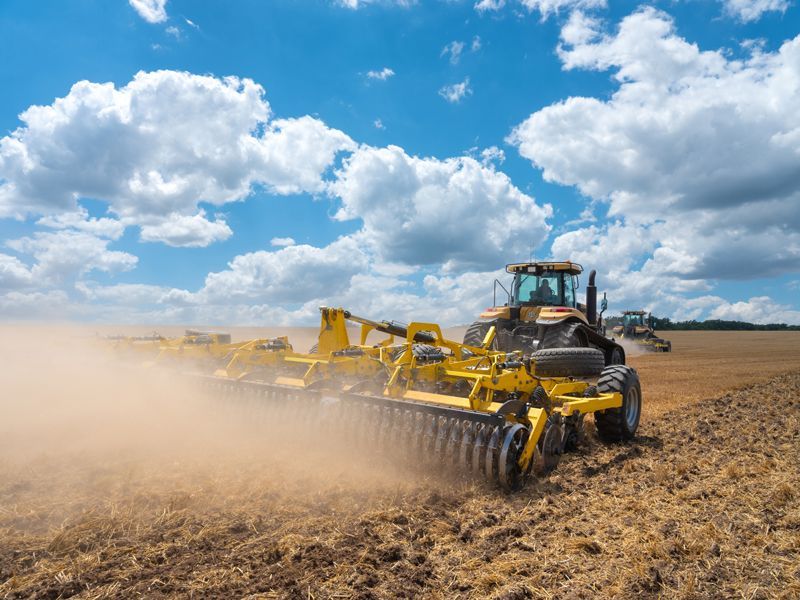 Tractor Preparing Soil In Wheat Field After Harvesting - Aberdeen, MS - Ground Pounders Tractor Preparing Soil In Wheat Field After Harvesting - Aberdeen, MS - Ground Pounders