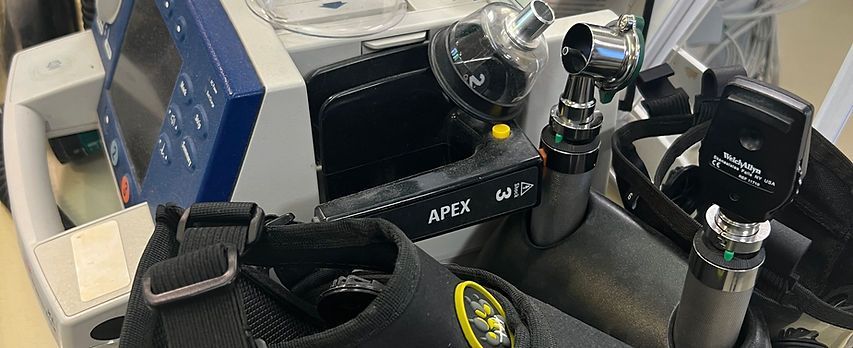 Firefighter rinsing oxygen muzzle under utility sink