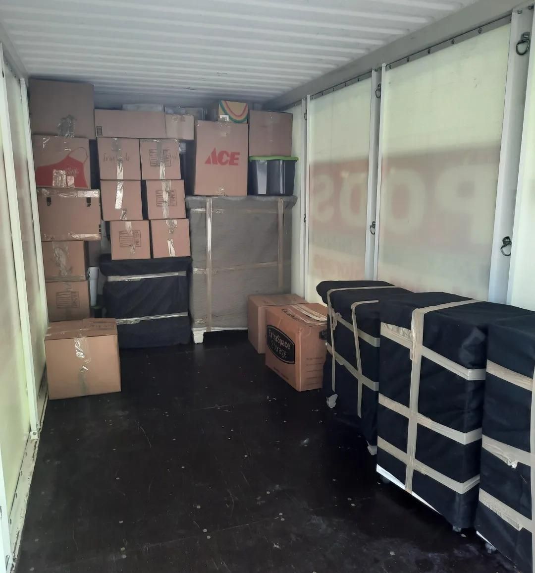 A room filled with boxes and a sign that says ace