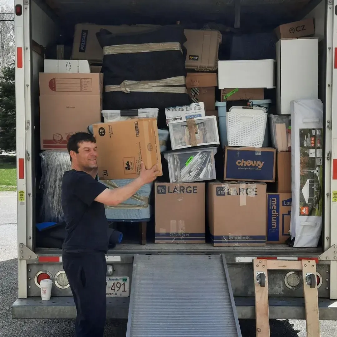 A man is standing in front of a large chewy box