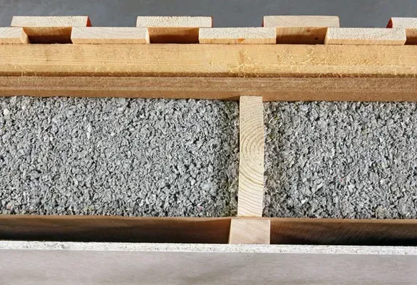 A close up of a piece of wood and concrete.