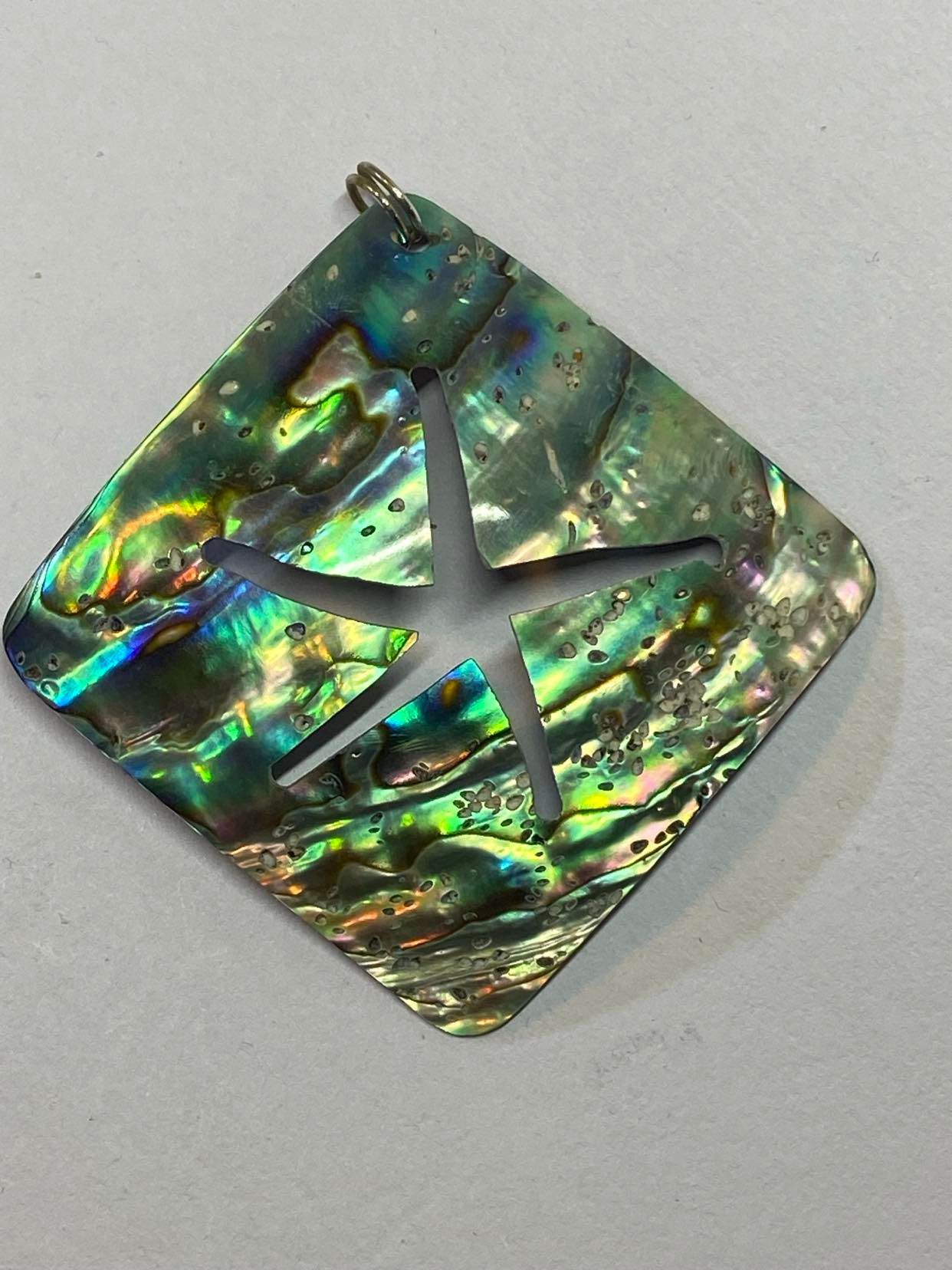 Square Paua Shell with Starfish design Paua Shell pendant with cut out of Starfish pattern.