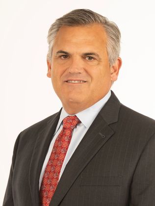 Attorney William J. Atkins in a suit and tie is smiling for the camera.