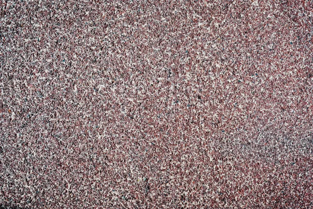 A close up of a carpet with a lot of small dots on it.