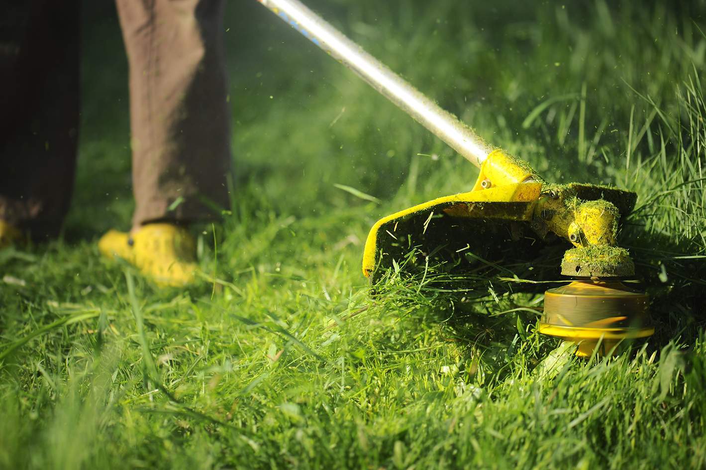 man mowing grass mower close