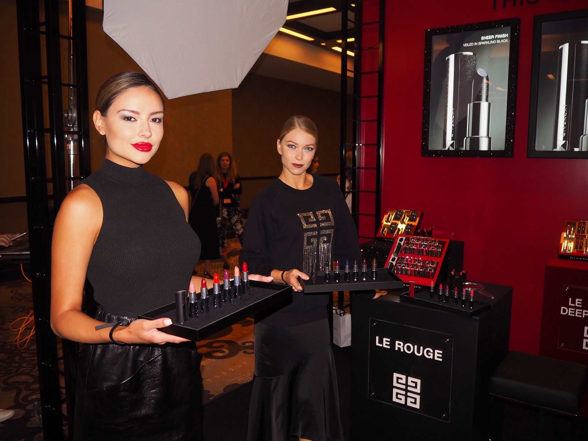 Glam models working the Givenchy beauty booth at Cosmoprof trade show in Las Vegas 2019.