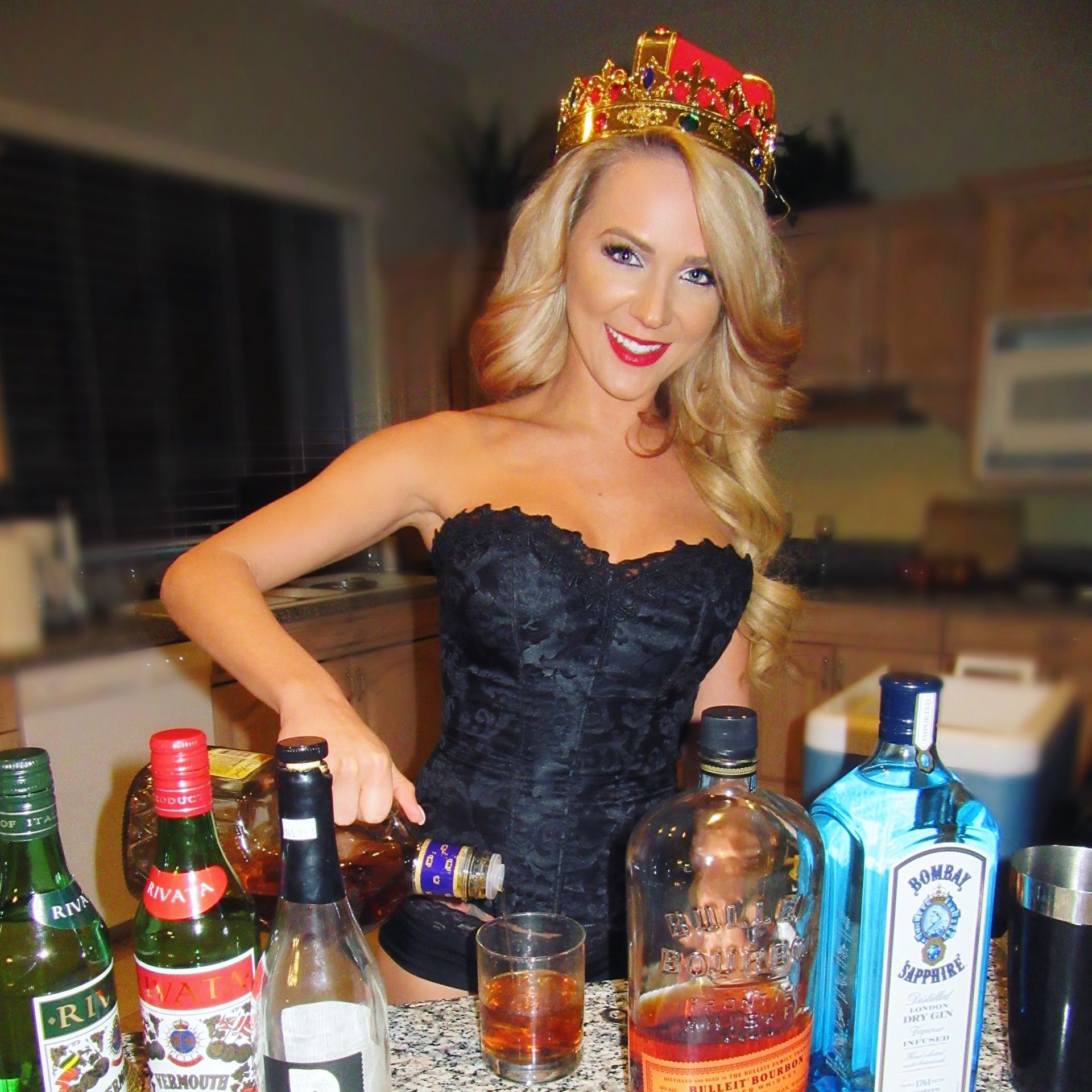 Blonde model bartender pouring drinks for guests at mens weekend retreat in Las Vegas.