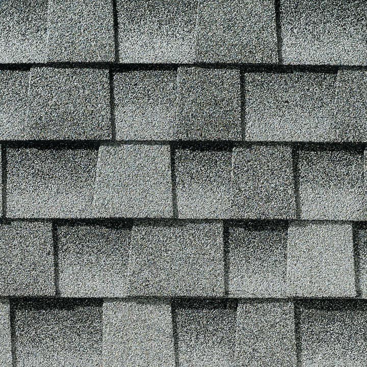 A black and white photo of a roof with shingles.
