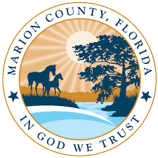 The seal of marion county florida shows two horses and a tree