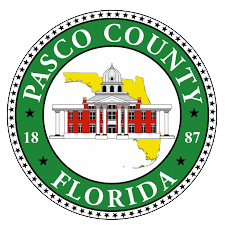 The seal of pasco county florida has a picture of a building in the center.