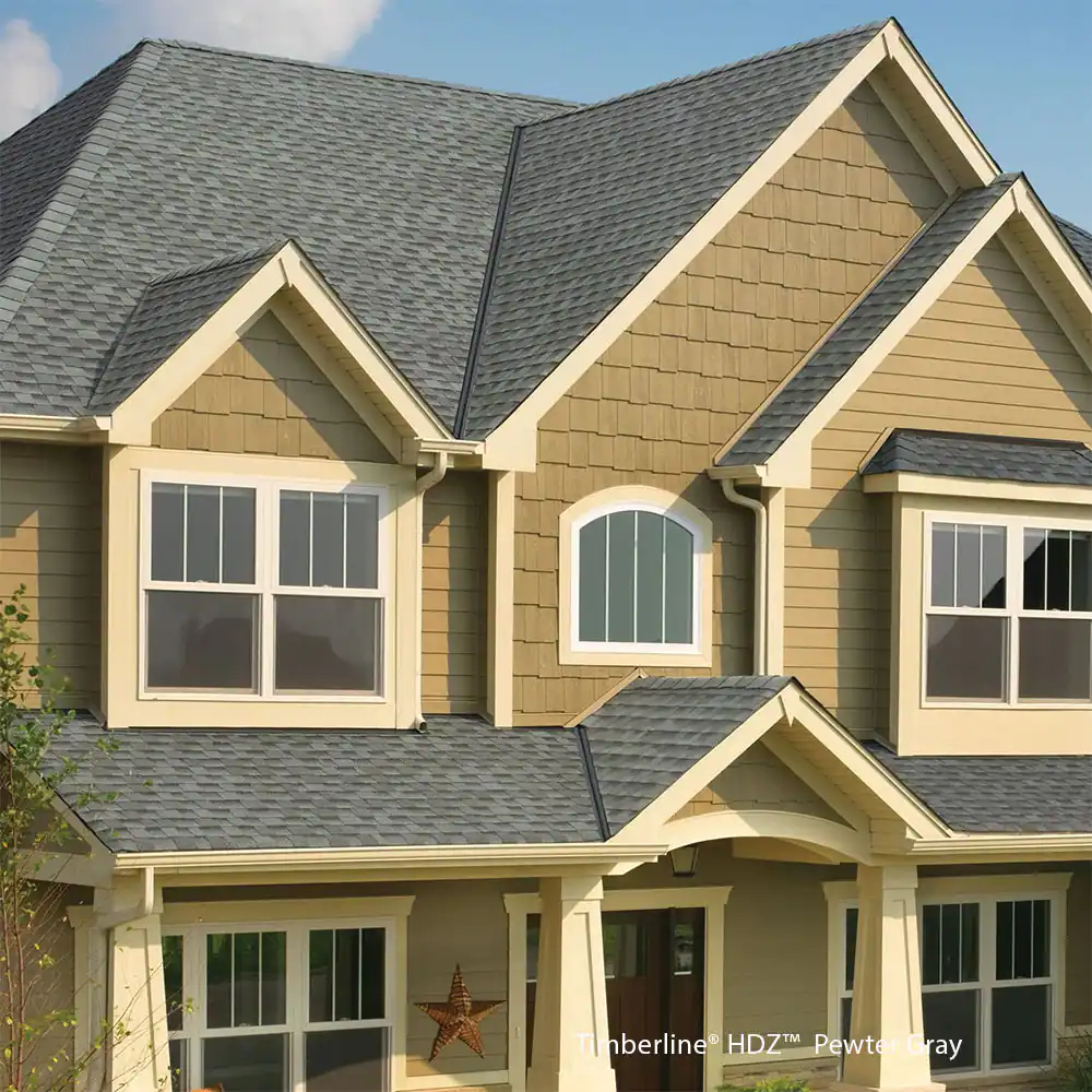 A large house with a gray roof and tan siding