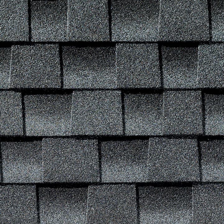A close up of a row of gray shingles on a roof.