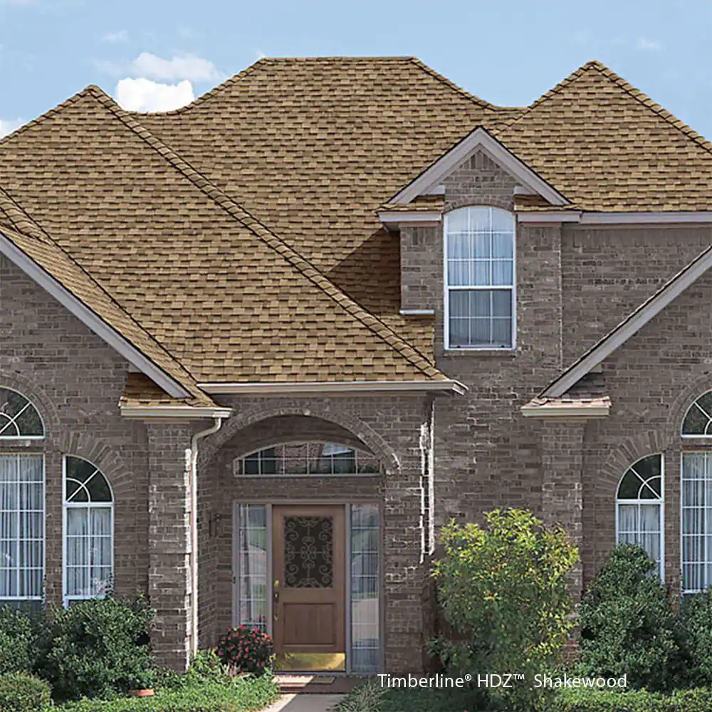 A large brick house with a brown roof and arched windows.