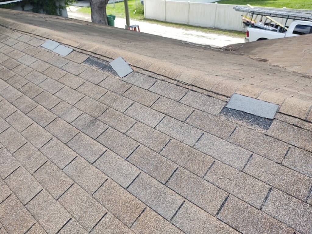 A close up of a roof with a truck parked in the background.