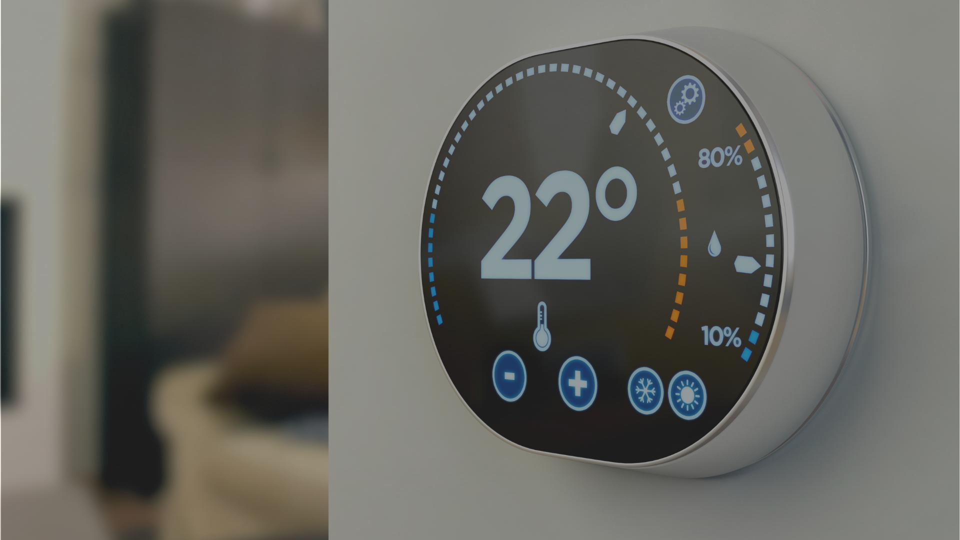 A thermostat on a wall shows the temperature is 22 degrees celsius