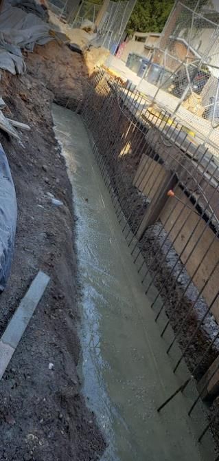 A construction site with a lot of dirt and concrete.
