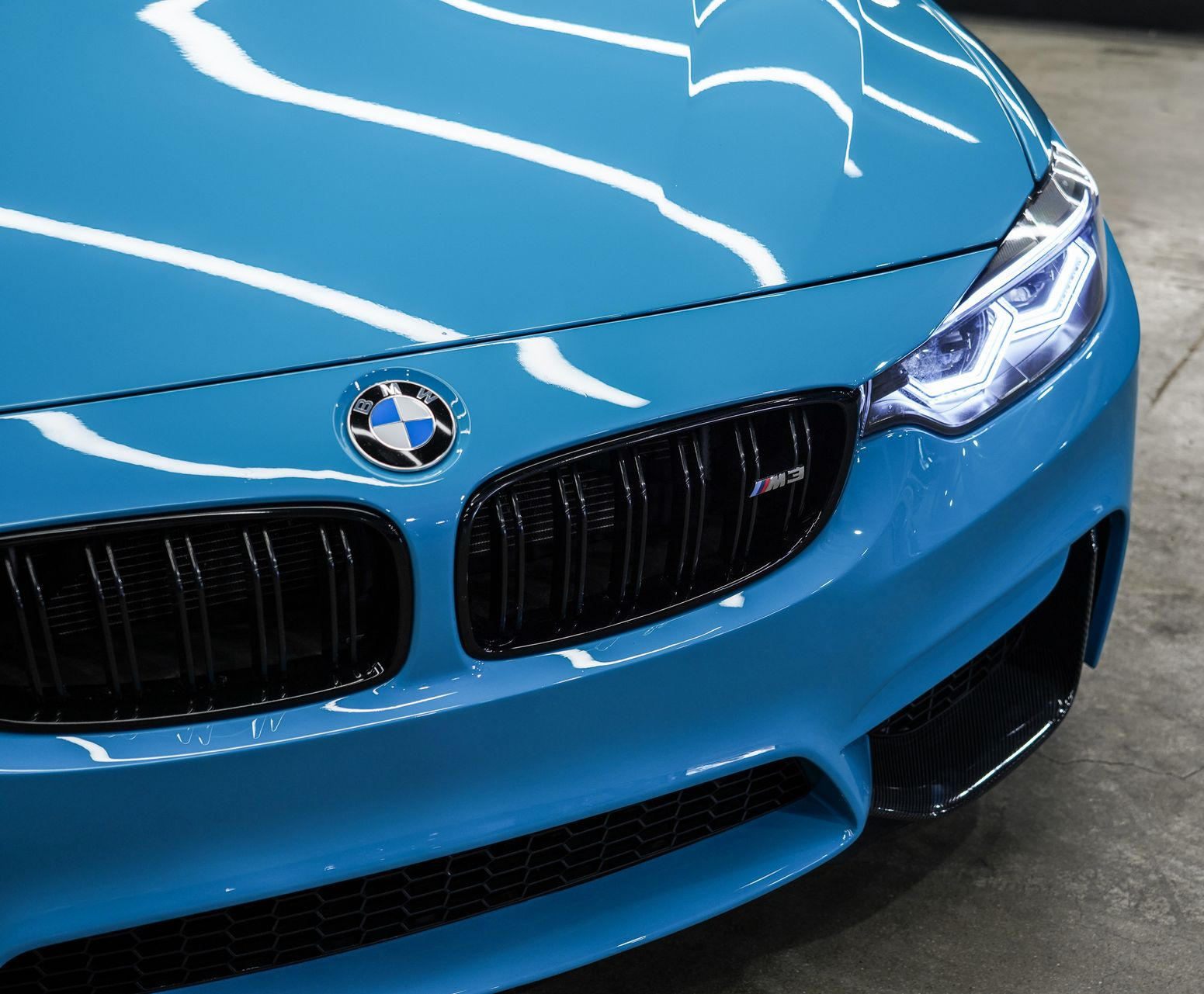 Blue BMW car front grille and headlights close-up