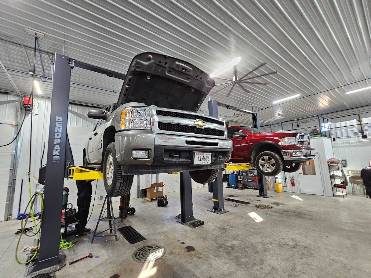 a truck is sitting on a lift in a garage .