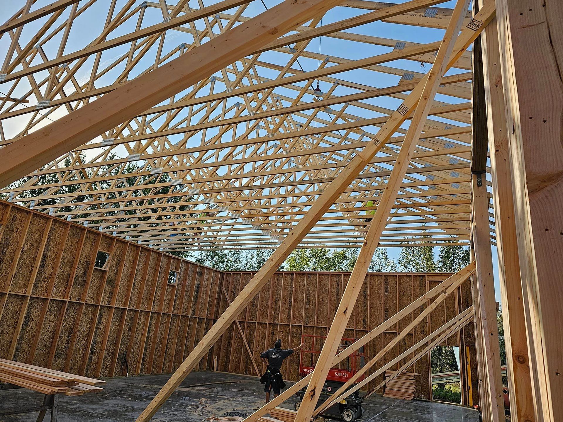 a building under construction with a lot of wooden beams .