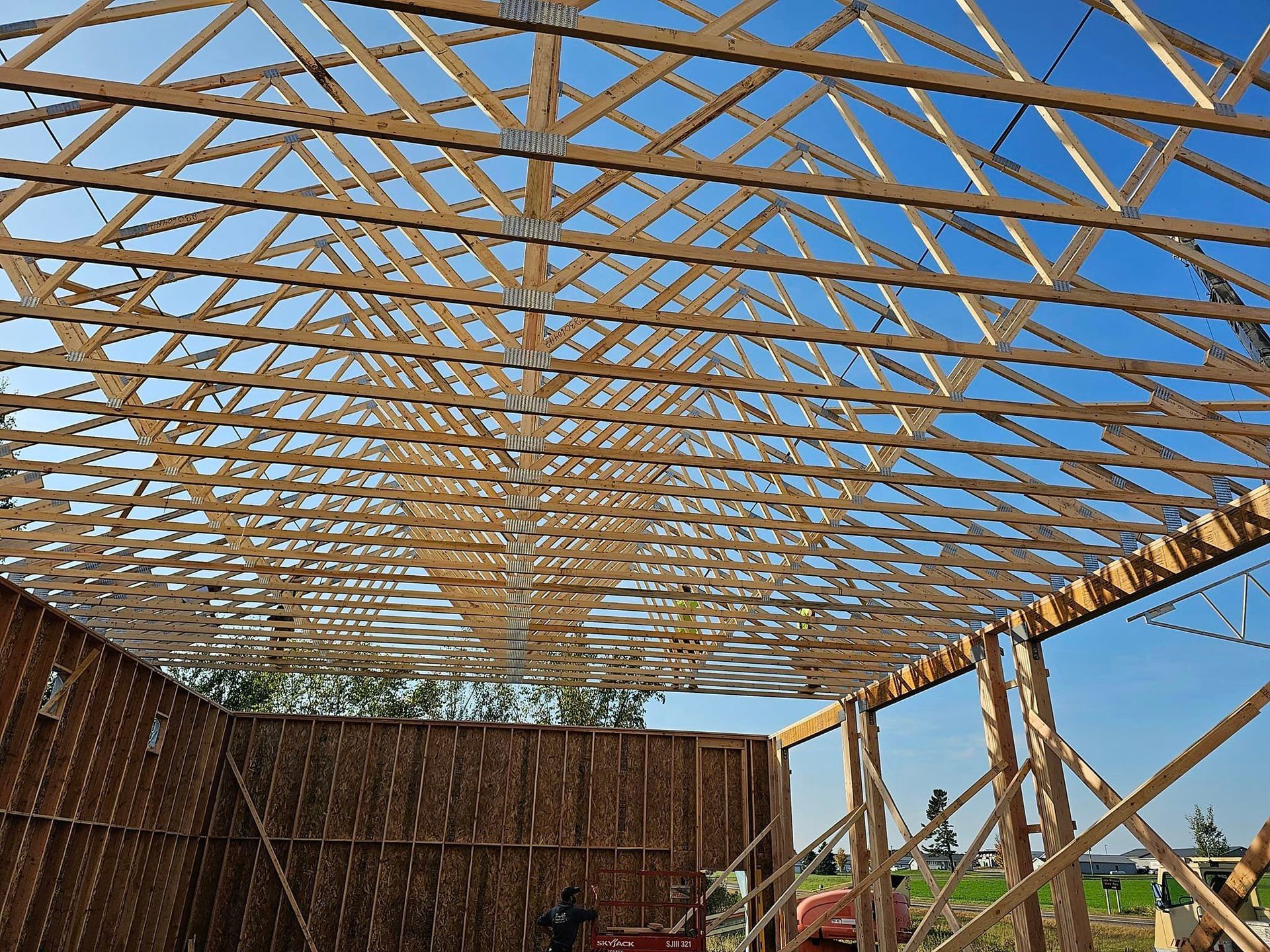 a large wooden structure under construction with a blue sky in the background .