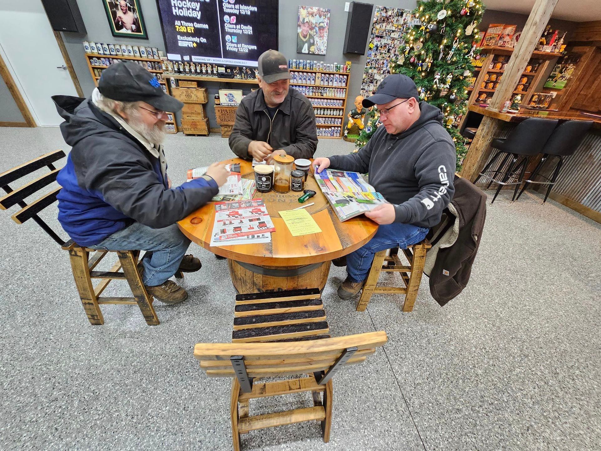 a group of men are sitting around a table playing a game .