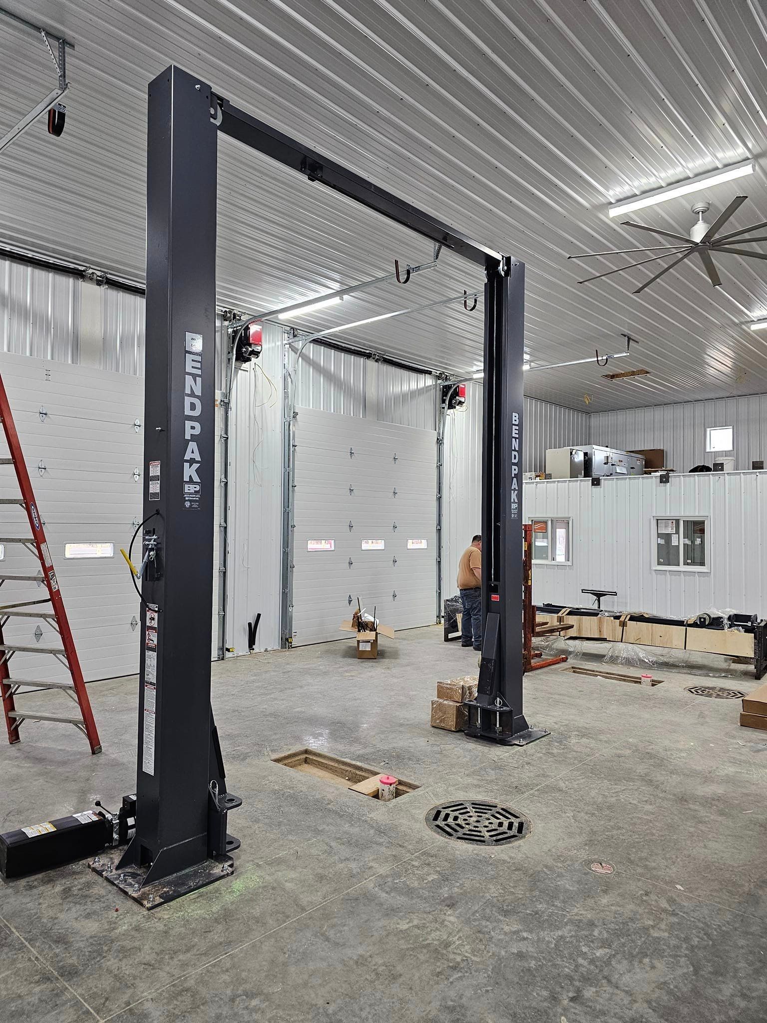 a garage with a lift and a ladder in it