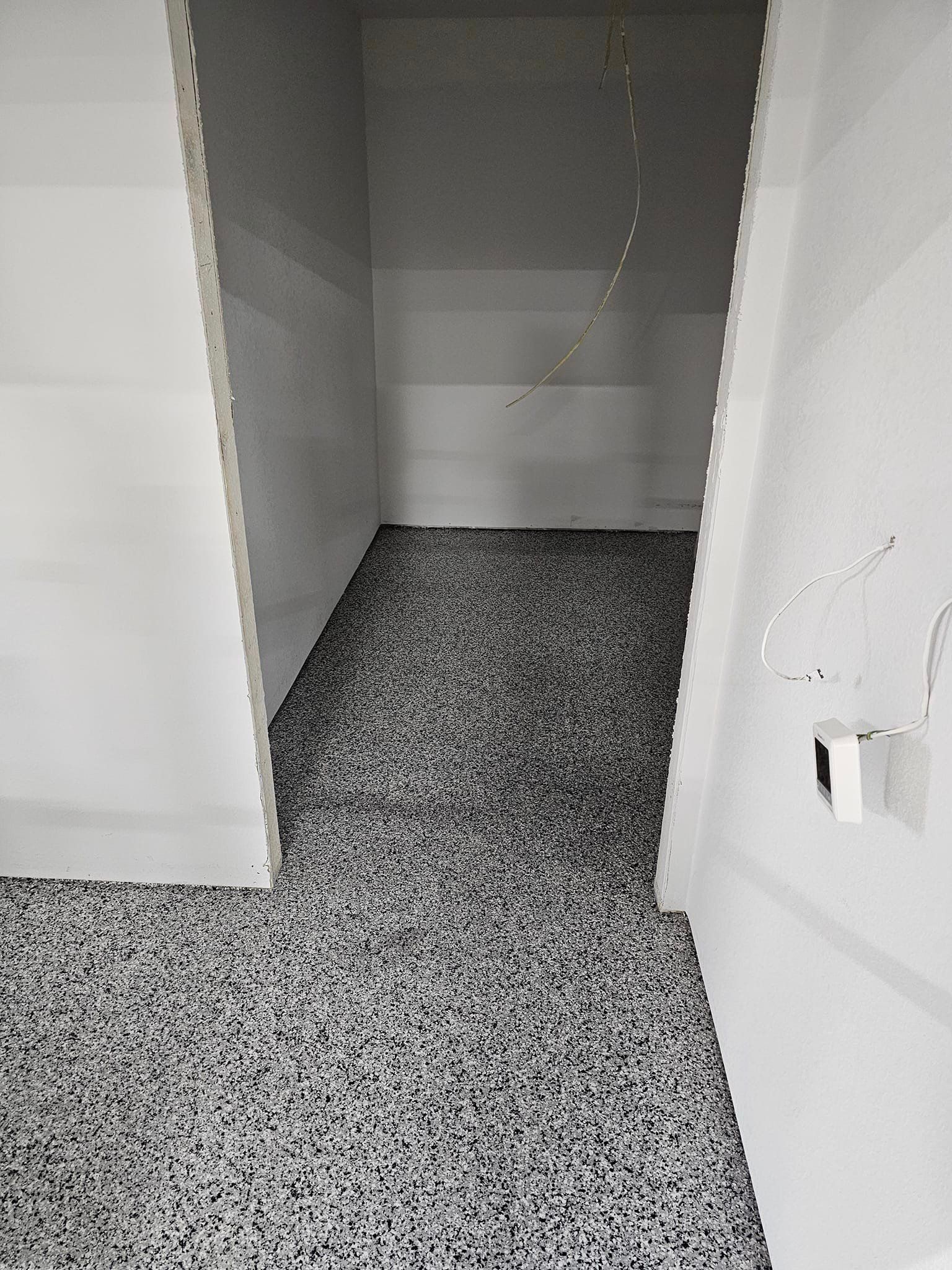 a black and white photo of a bathroom with a tiled floor .