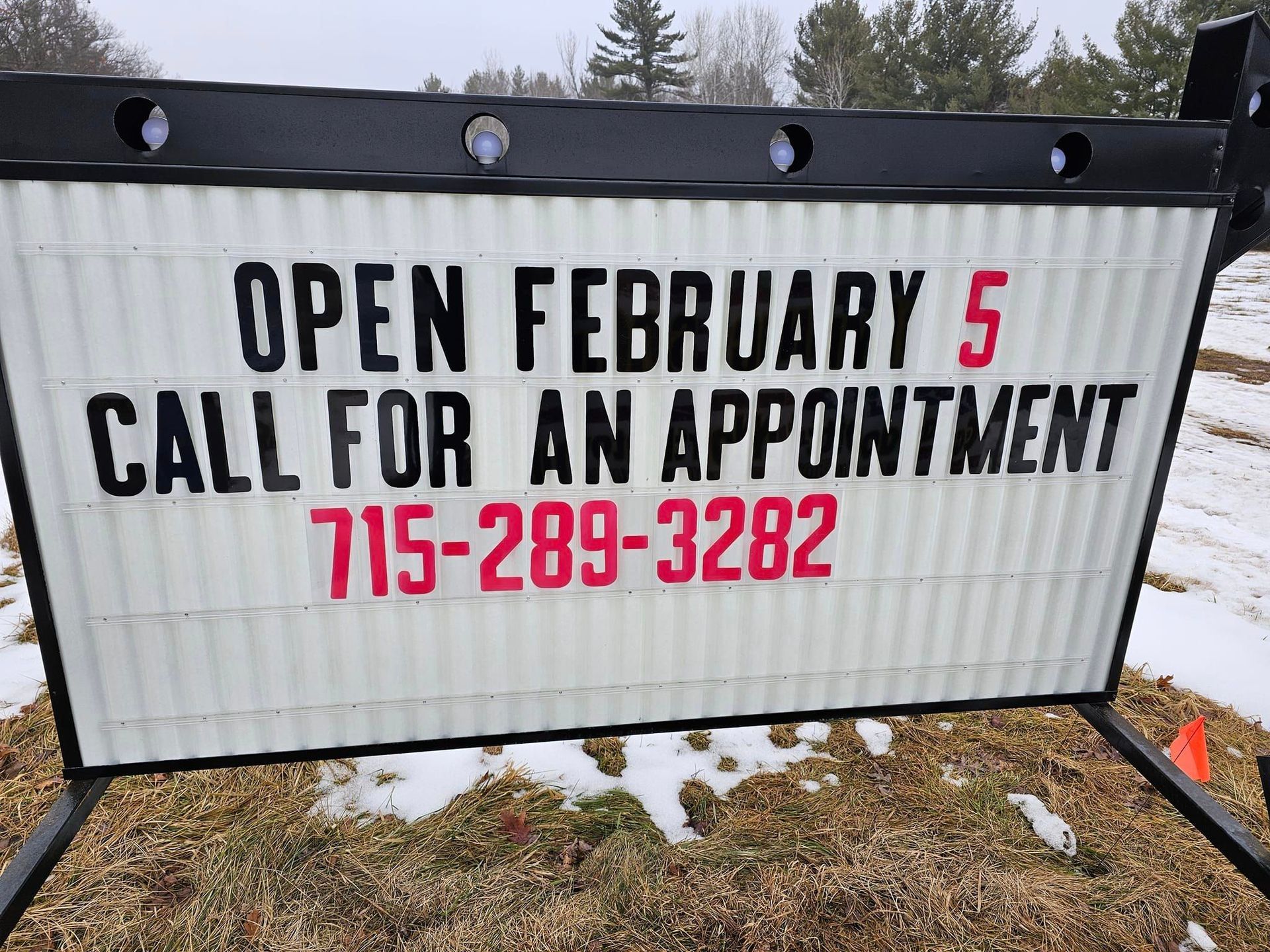 a sign that says open february 5 call for an appointment