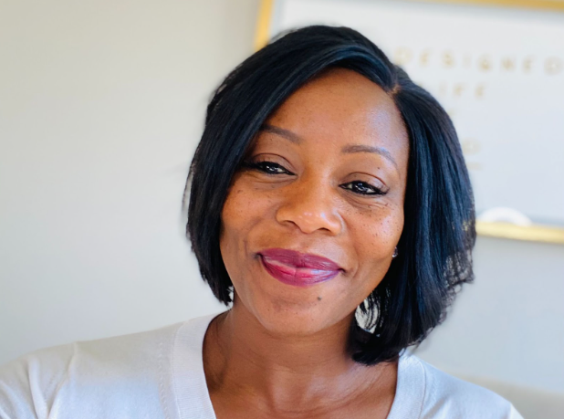 woman smiling facing the camera.