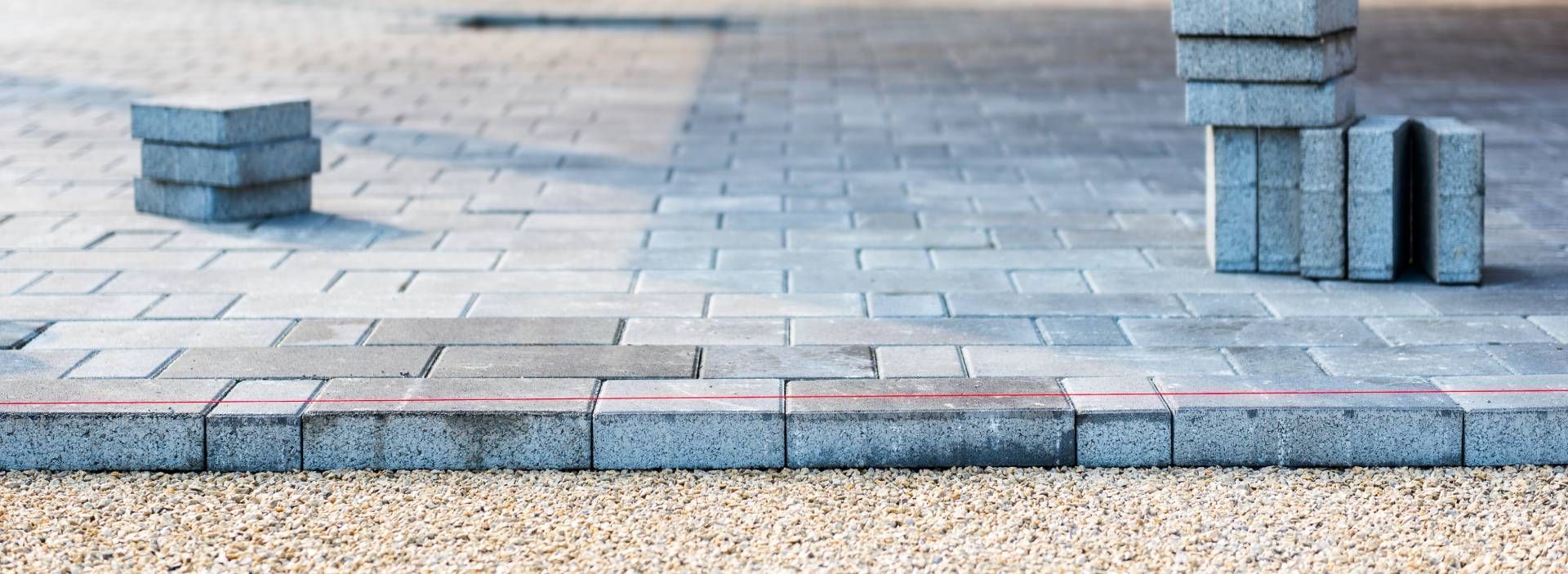 A row of bricks sitting on top of each other on a sidewalk.