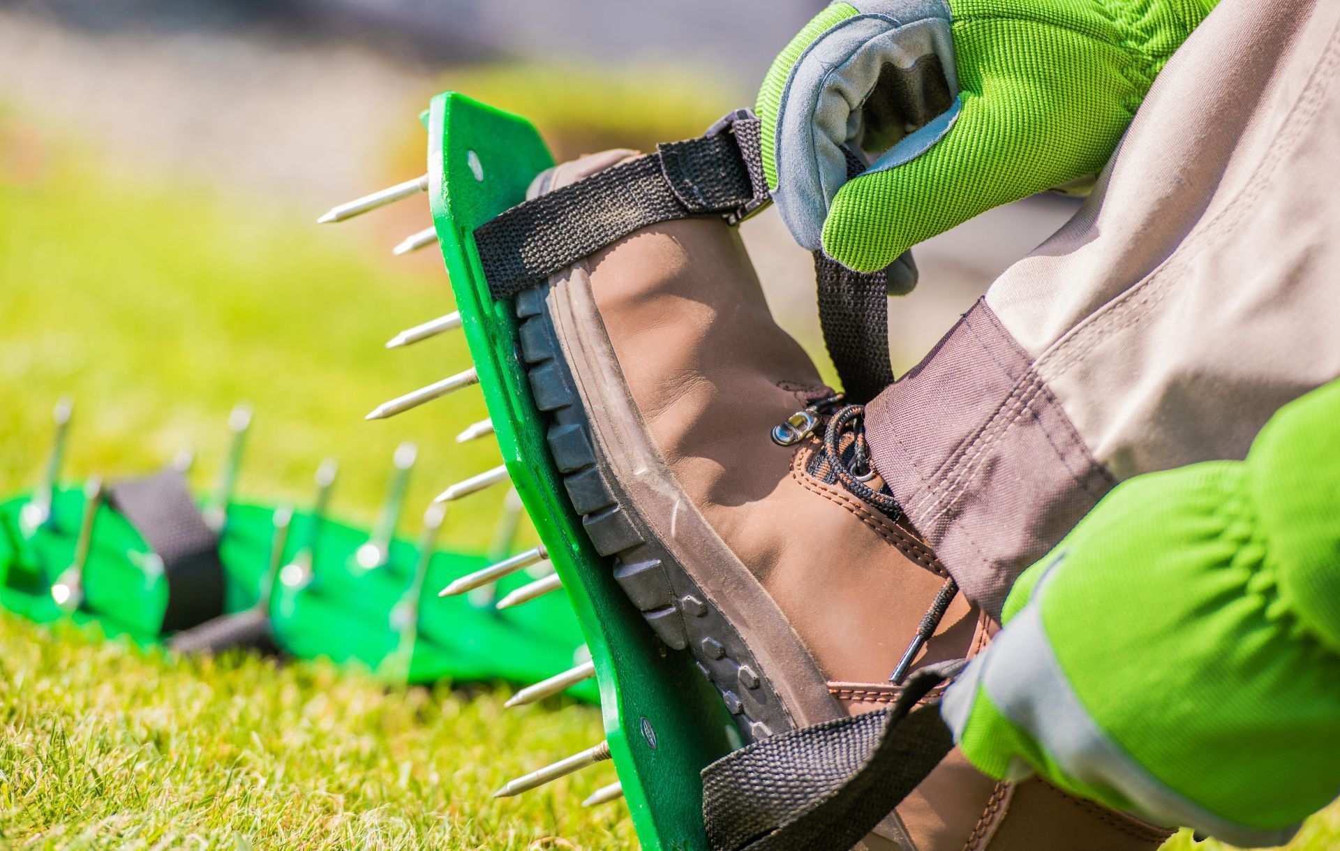 A person is wearing a pair of shoes with spikes on them.