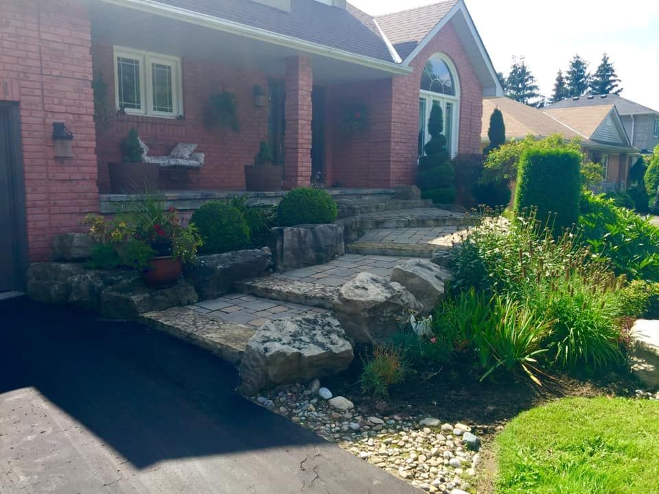 A brick house with a stone walkway leading to the front porch.