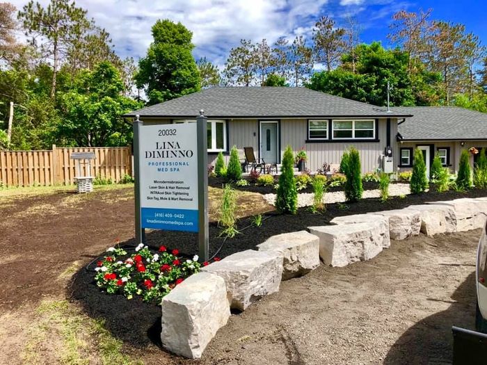 A house with a for sale sign in front of it