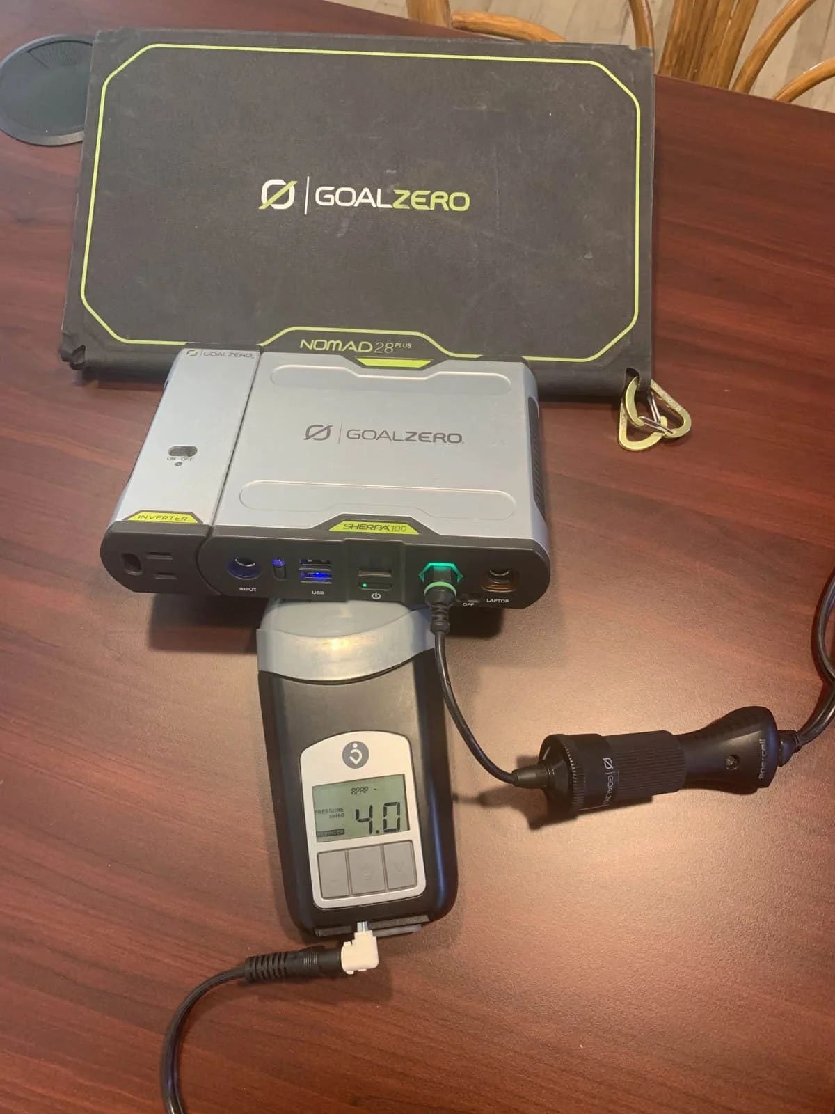 Goal Zero solar panel charging a portable power station and a device displaying 4.0.
