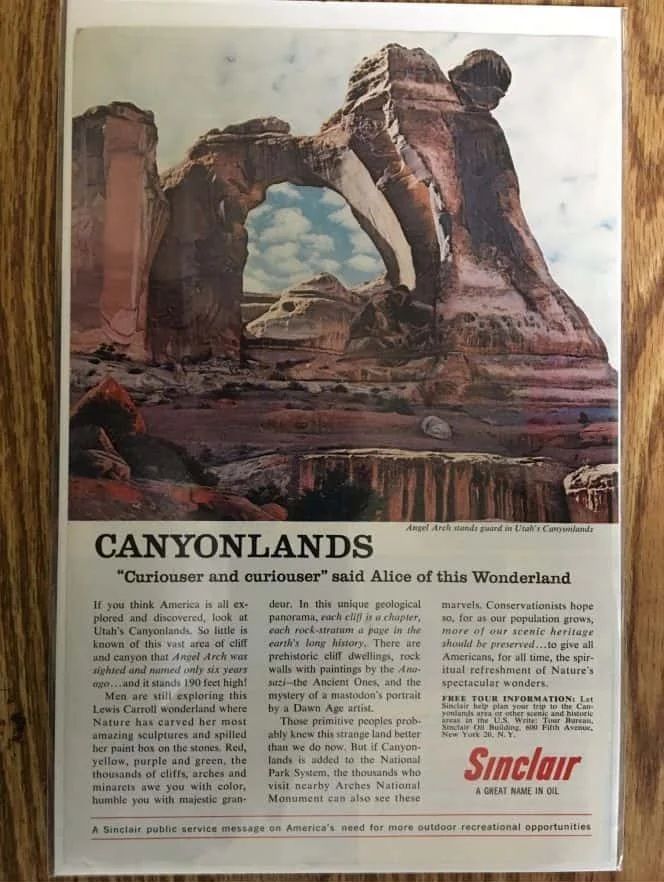Advertisement for Canyonlands with an arch-shaped rock formation, Sinclair logo.
