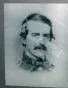 Portrait of a man with dark hair, a mustache, and formal attire.