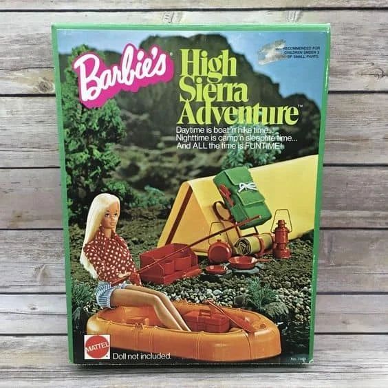 Barbie's High Sierra Adventure box. Barbie doll sits in an orange raft. Camping gear is in the background.