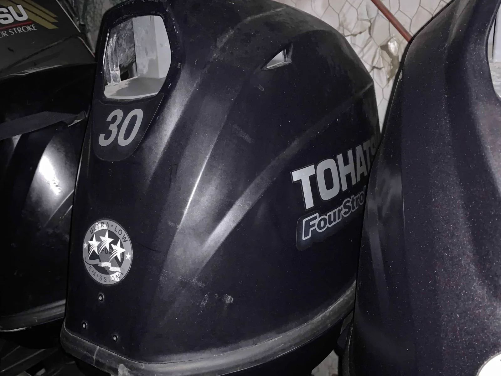Black Tohatsu 30 horsepower four-stroke outboard motor.