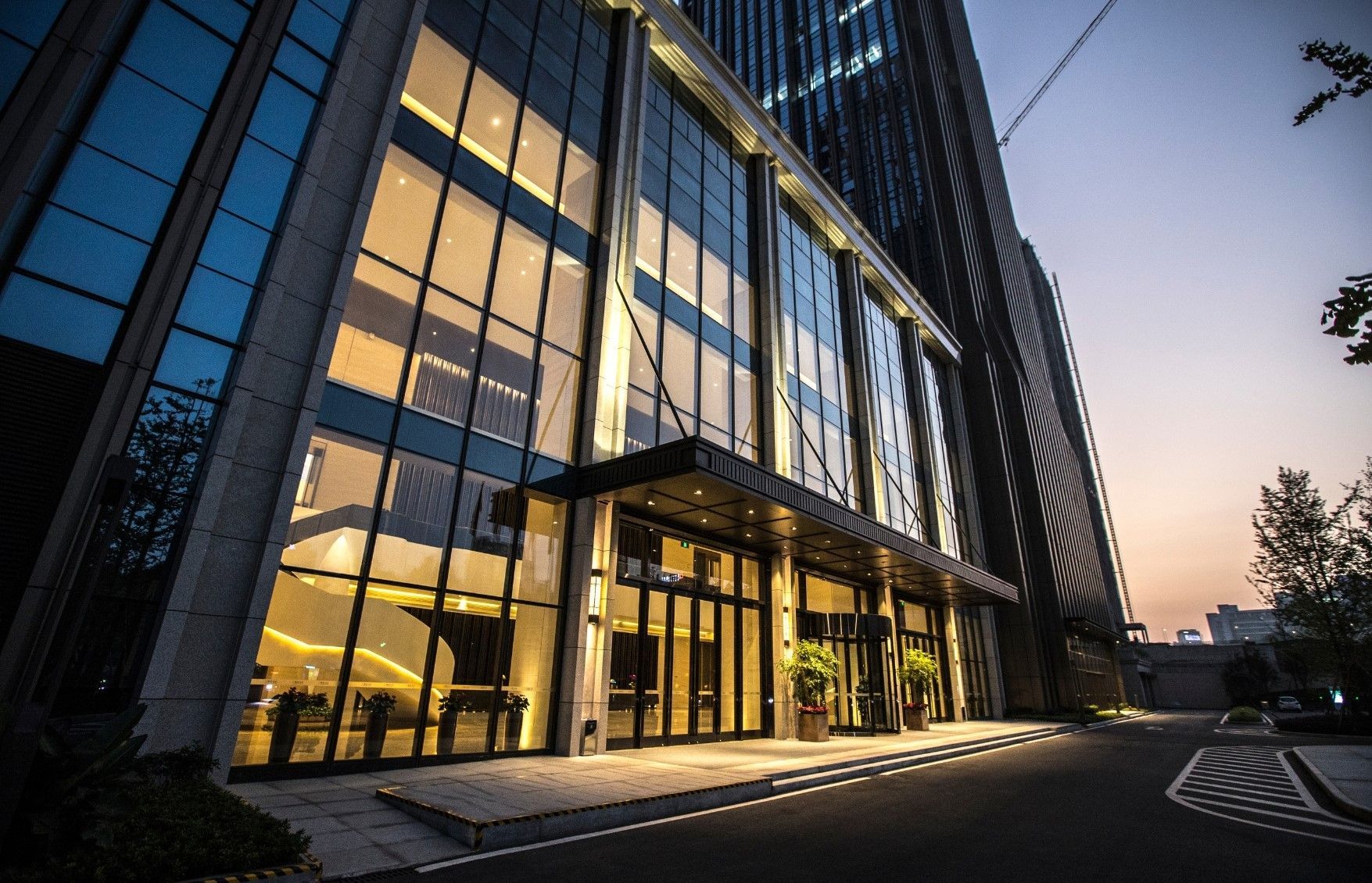 A large building with a lot of windows is lit up at night.