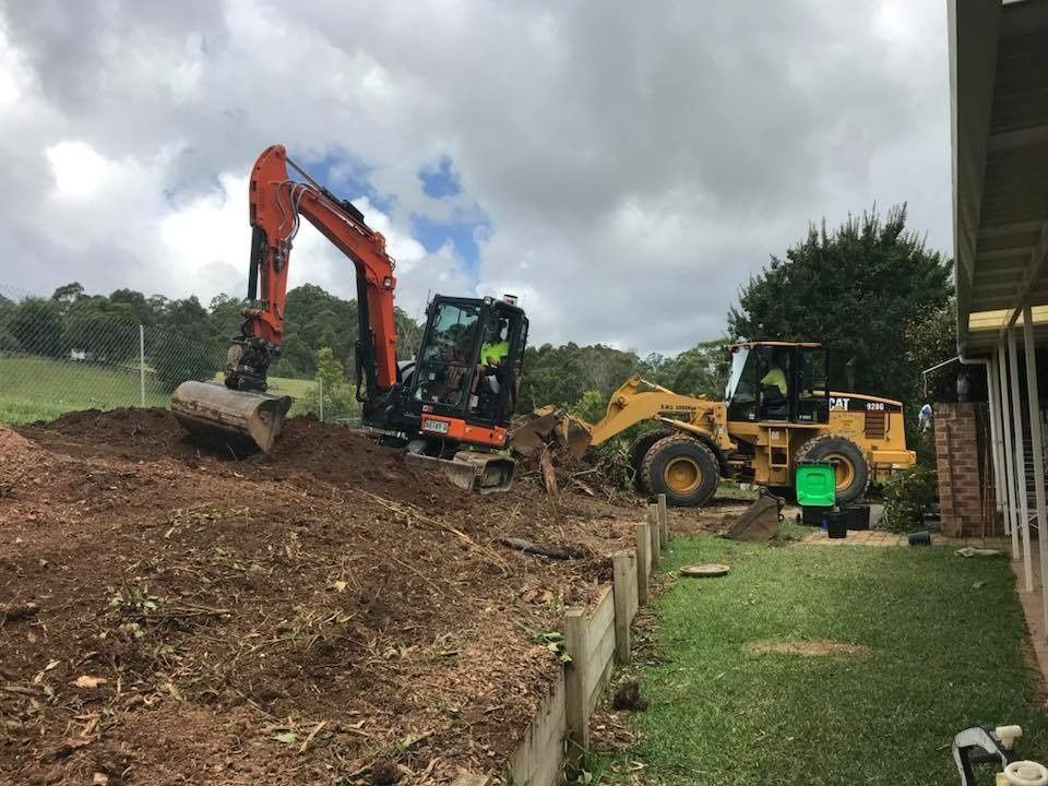 A Two Construction Vehicles Excavate Soil — B & D Bunt Earthmoving Contractors in Nambucca Heads, NSW