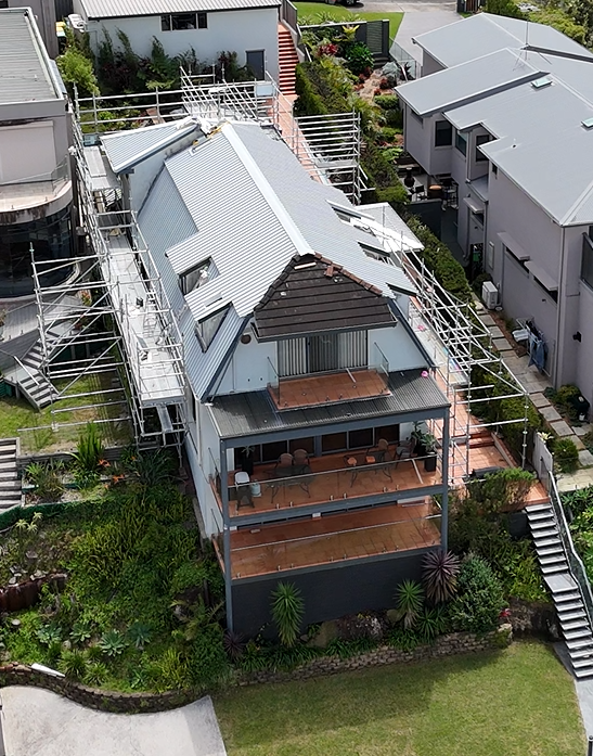 An aerial view of a house with scaffolding on the roof