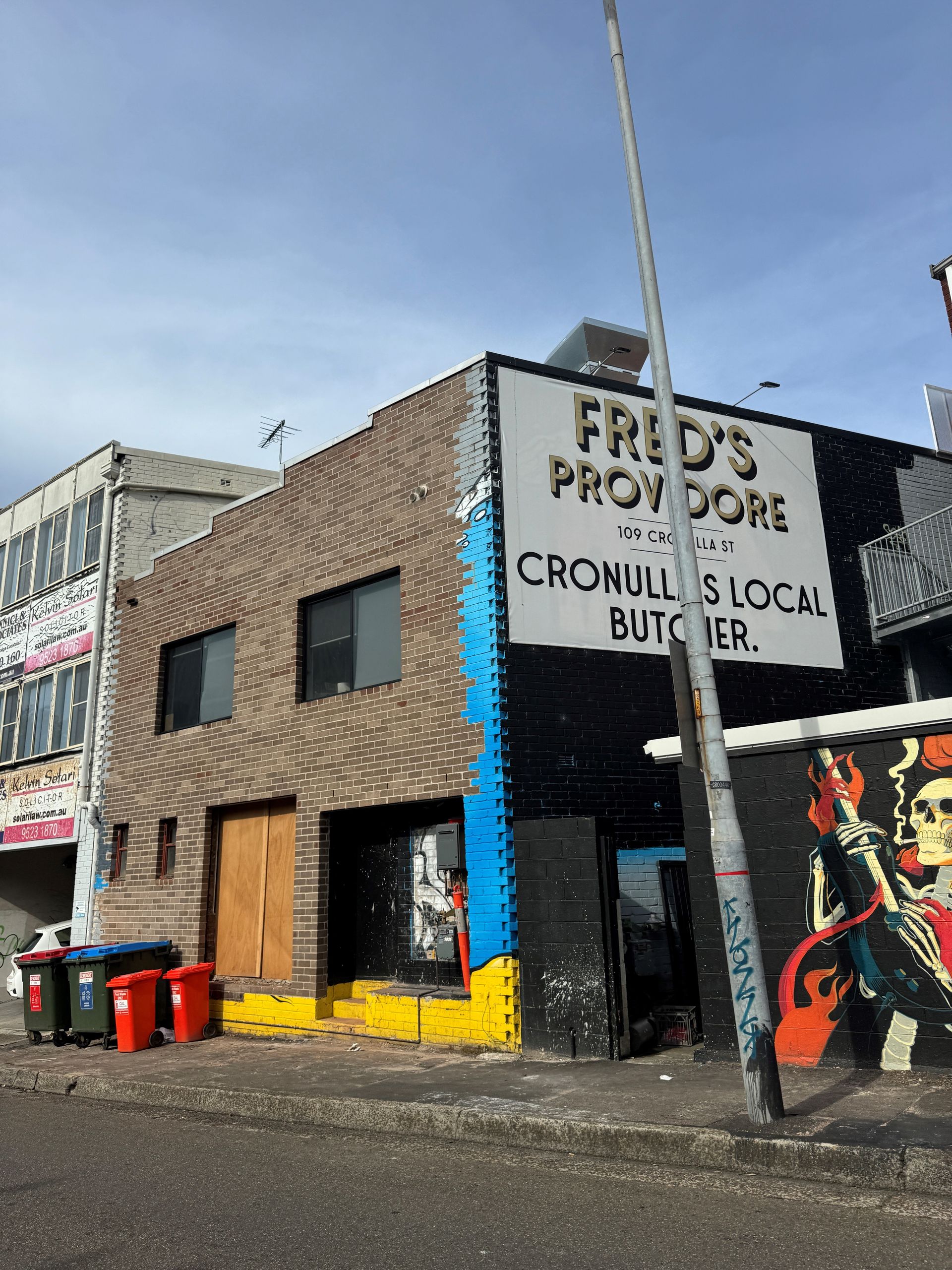 A brick building with a sign that says fred 's provisions