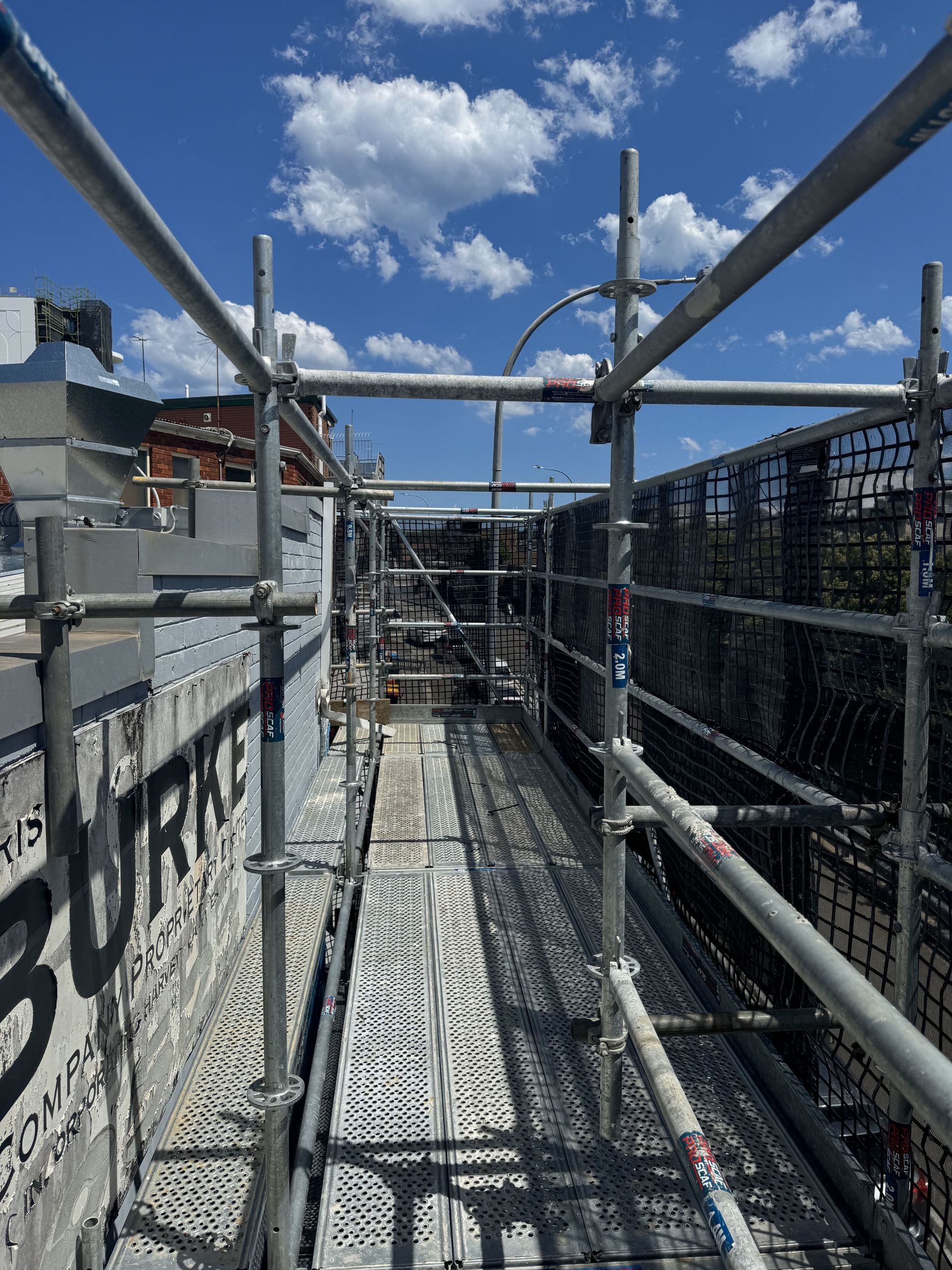 A construction site with scaffolding and a blue sky in the background