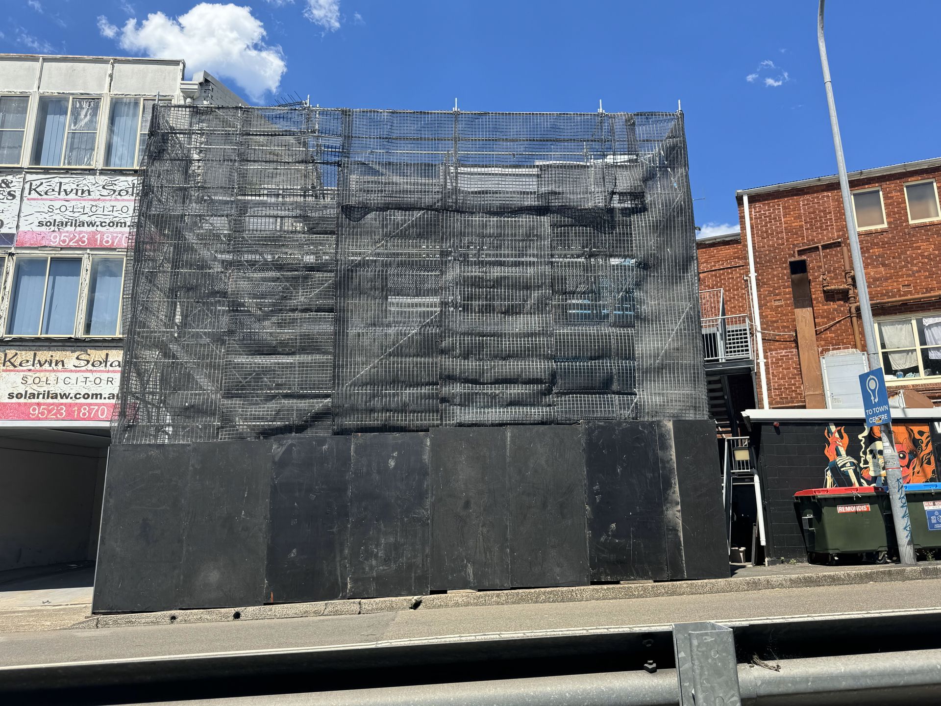 A building with a lot of scaffolding on it is being demolished.