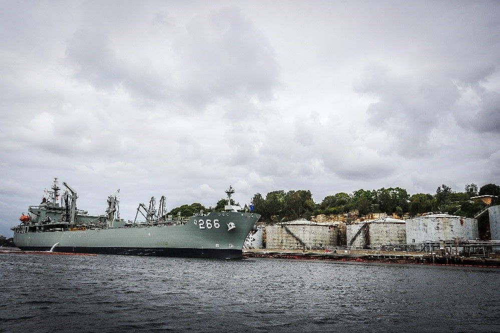 A large ship is docked in a body of water.