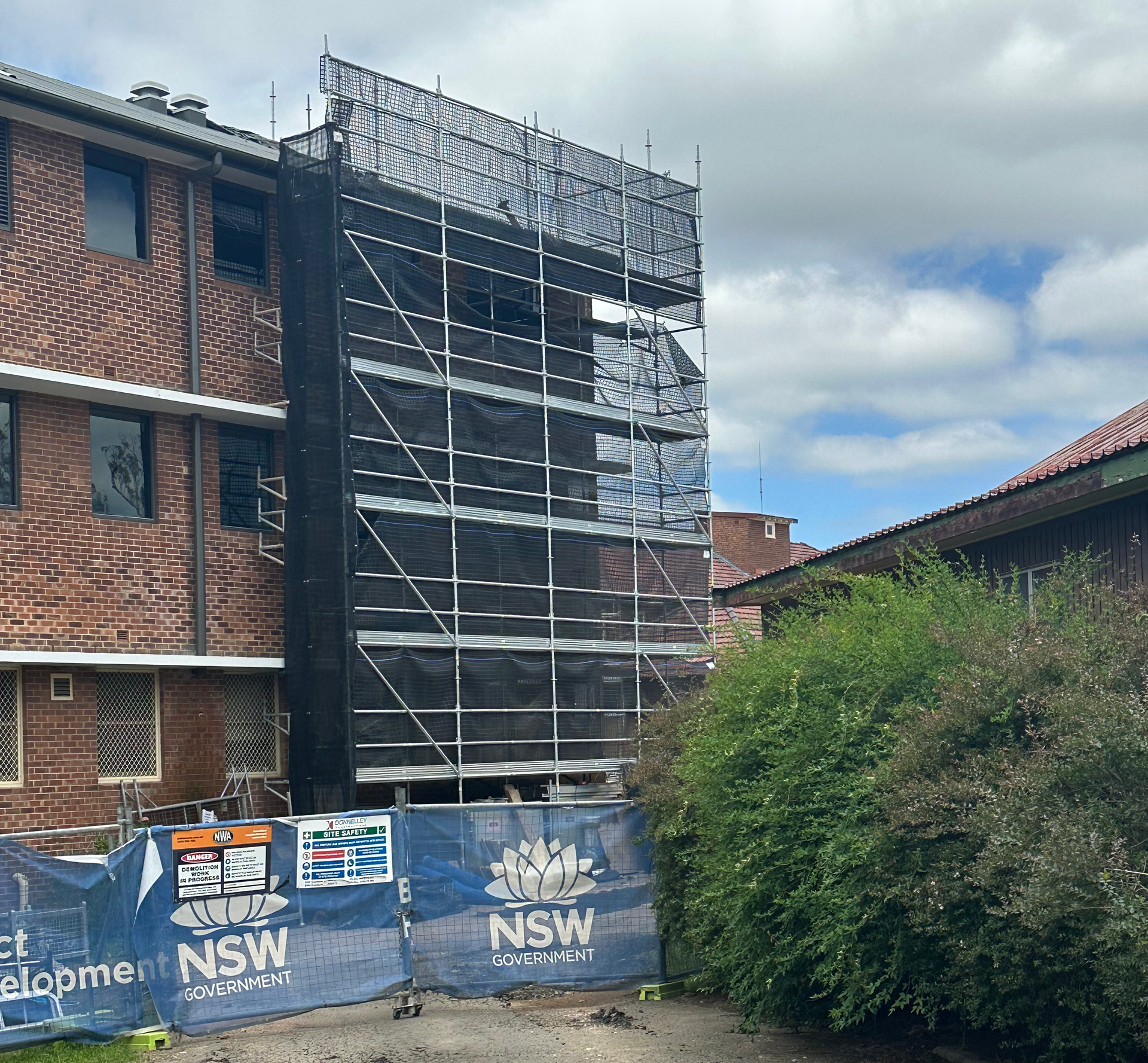 A group of construction workers are working on a building under construction.