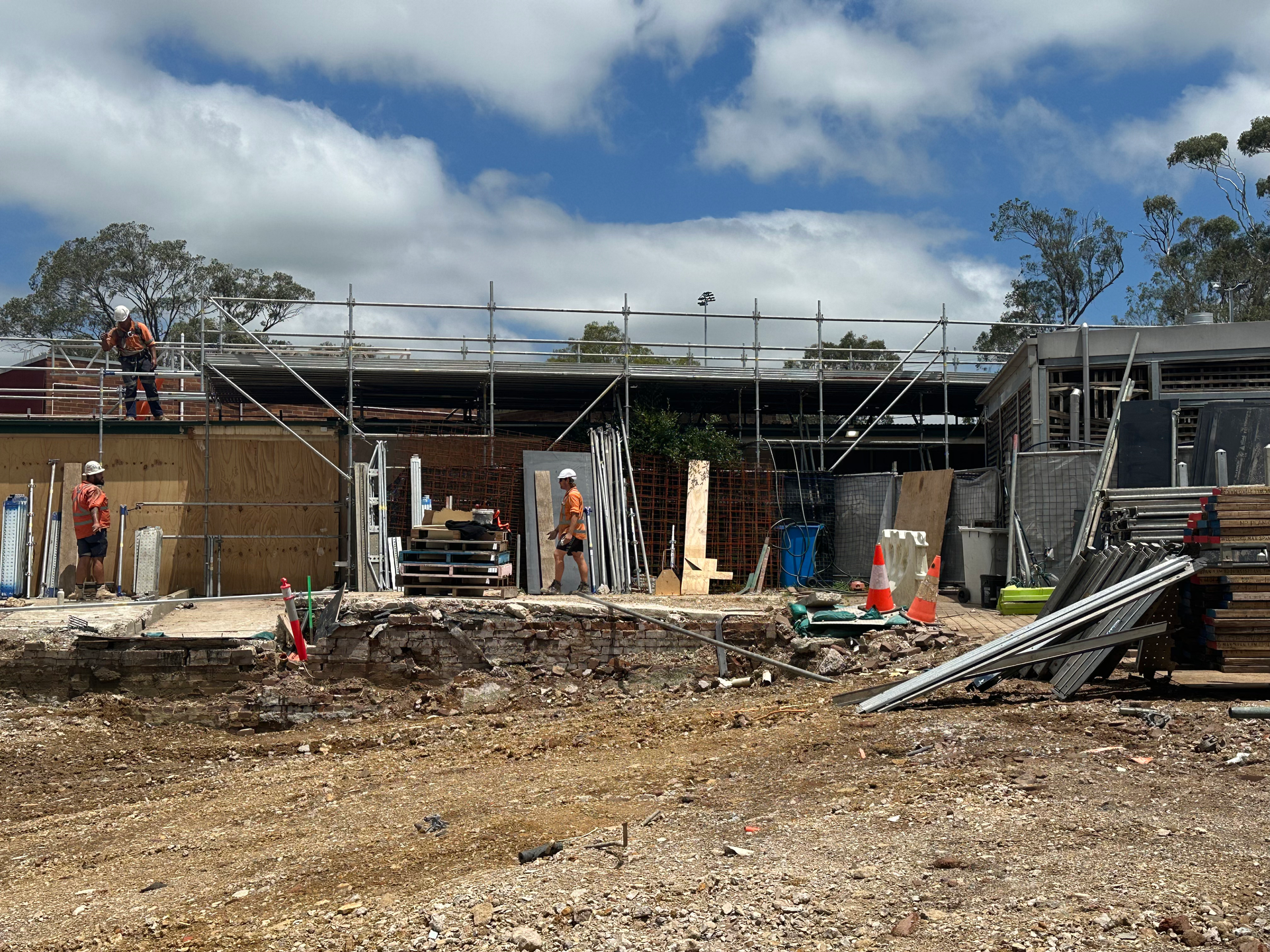 A group of construction workers are working on a building under construction.